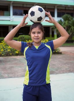 Portrait of a female athlete and ball.
Who puts the ball on their head.