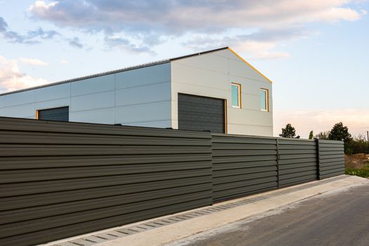 Big metal industrial storage shed building.  Exterior of warehouse, no brands on storehouse with copy space.