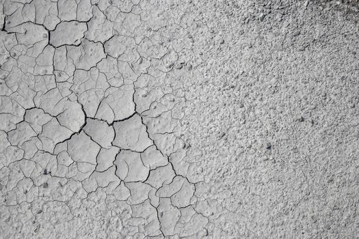 Dried cracked clay texture and gravel stones