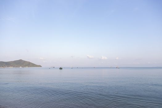 Sea with fishing boats and blue sky