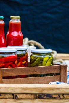 Bottles of tomato sauce, preserved canned pickled food concept isolated in a rustic composition.