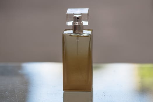 Elegant perfume bottle isolated on blurred background with copy space.