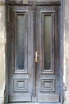 vintage entrance wooden gray door with glass close up