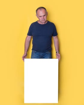 man in black shirt holding a blank board