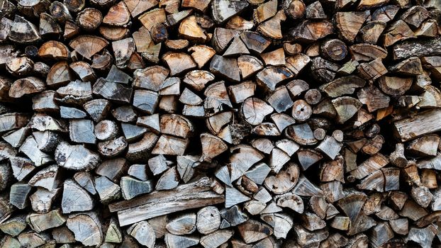 Stack of firewood, chopped firewood background.