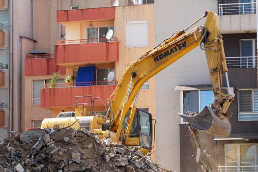 Varna, Bulgaria - August, 04,2020: excavator demolishes a house in a residential area