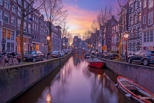 City scenic from Amsterdam at the Oude Zijdsvoorburgwal in the Netherlands at sunset