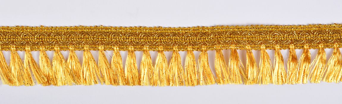 Braid lace made Luxury Metallic golden cord on white background. decoration for carnival and dance clothes costumes. Christmas texture. banner for website