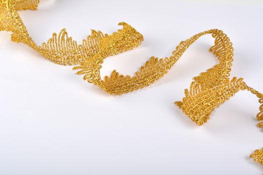 Braid lace made Luxury Metallic golden cord on white background. decoration for carnival and dance clothes costumes. Christmas texture. banner for website
