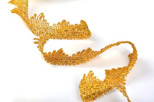 Braid lace made Luxury Metallic golden cord on white background. decoration for carnival and dance clothes costumes. Christmas texture. banner for website