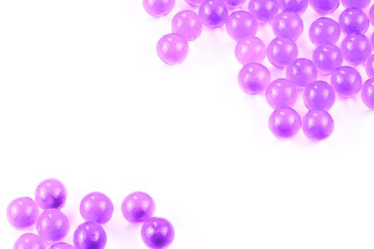 proton purple spherical ball capsules with selective focus isolated on white background.