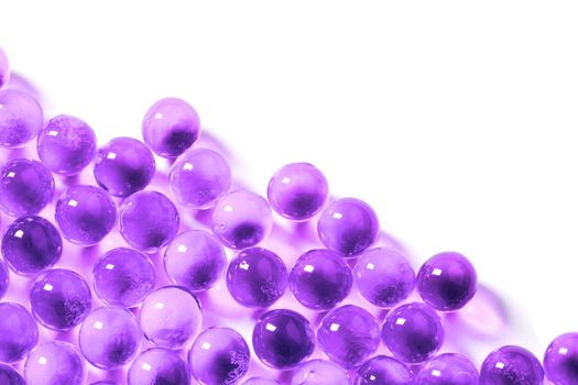 proton purple spherical ball capsules with selective focus isolated on white background.