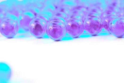 cyanspherical ball capsules with selective focus isolated on white background.