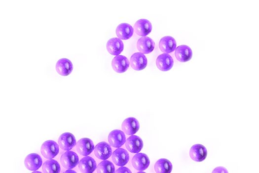 proton purple spherical ball capsules with selective focus isolated on white background.