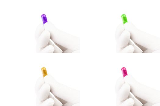 set of hand in medical glove holding colored organic med capsule isolated on white background closeup.