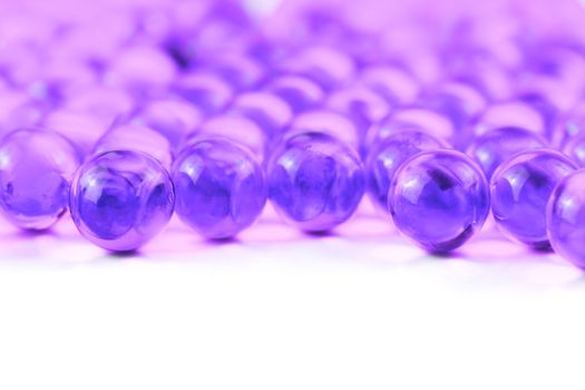 proton purple spherical ball capsules with selective focus isolated on white background.