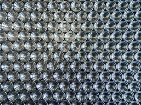 Shiny metal parts after cnc turning, on flat surface top-down flat lay background.