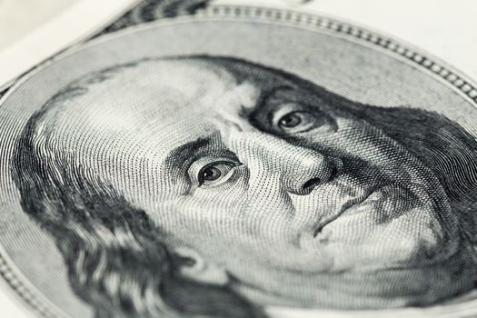 A close view of engraving portrait of Ben Franklin of old one hundred us dollars banknote. Selective focus with natural lens blur.