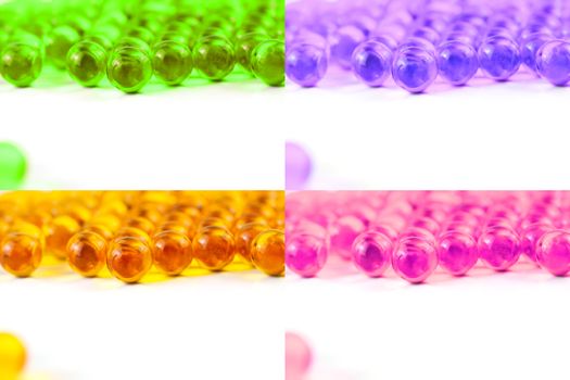 set of colored spherical ball capsules of fish oil selective focus isolated on white background.
