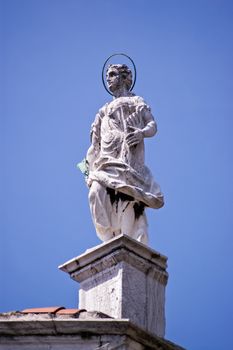 Statue of Saint Jerome on the roof of the church of San Sebastiano constructed in the mid 16th century in Venice, Italy.