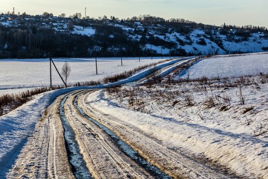 rustic road track at winter thaw daylight with nobody on it