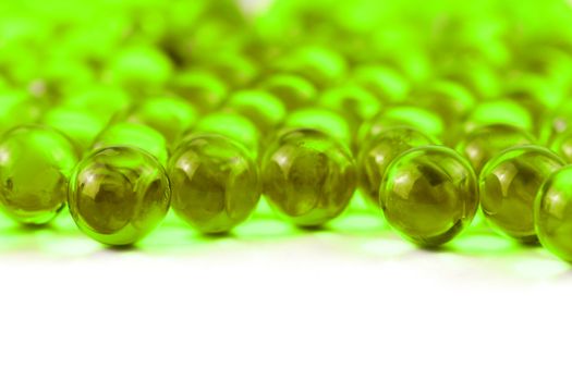 proton purple spherical ball capsules with selective focus isolated on white background.