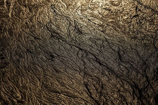 abstract mud background with water washout trails and selective focus.