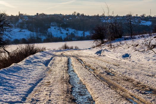 rustic road track at winter thaw daylight with nobody on it and selectife focus and shallow depth of field