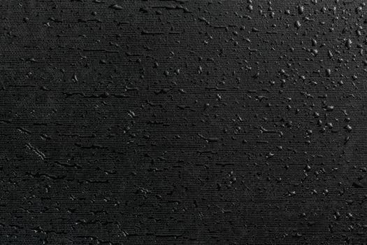 water drops on black flat rubber surface dark macro background