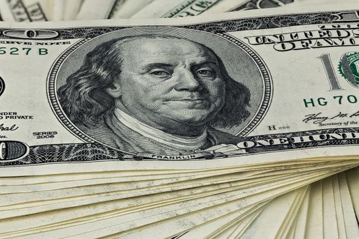 a skewed stack of old us dollar banknotes - close shot.