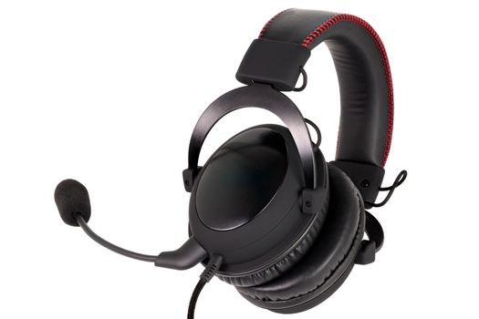 close view of wired black gaming headphones with microphone isolated on white background.