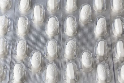 white tablets in blister closeup with selective focus.