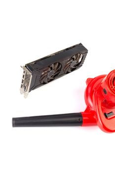 Electrical air blower and dusty pc video card isolated on white background.