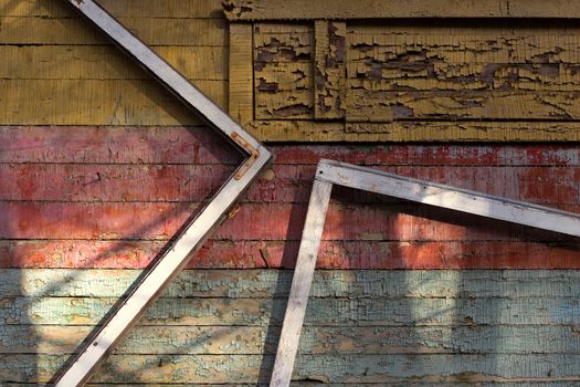 Abstract composition with a frames on old wooden wall with weathered peeling paint