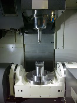 The five-axis Computer Numerical Control CNC machine waiting for stock change.