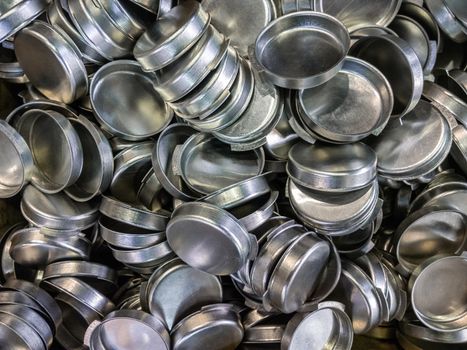 batch of olod stamped shiny metal caps, selective focus top-down wiew.