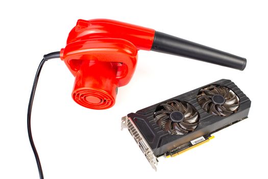 Electrical air blower and dusty pc video card isolated on white background.