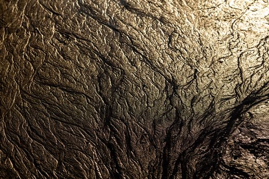 abstract mud background with water washout trails and selective focus.