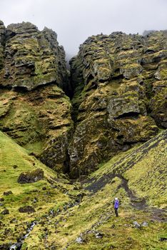 Iceland hiking tourist hiker sightseeing visiting Raudfeldsgja Canyon gorge rift nature landscape on the Snaefellsnes peninsula, West Iceland.