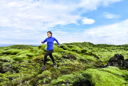 Running woman athlete trail runner - running woman exercising. Fit female sport fitness model training jogging outdoors living healthy lifestyle in beautiful nature, Iceland.