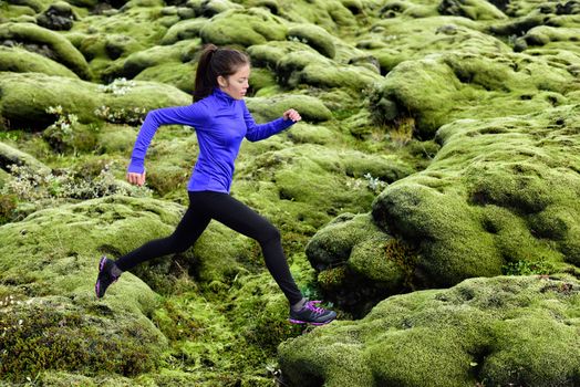 Fitness Athlete trail runner - running woman exercising. Fit female sport fitness model training jogging outdoors living healthy lifestyle in beautiful nature, Iceland.