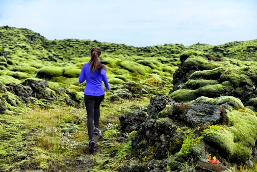 Running woman athlete trail runner - running woman exercising. Fit female sport fitness model training jogging outdoors living healthy lifestyle in beautiful nature, Iceland.