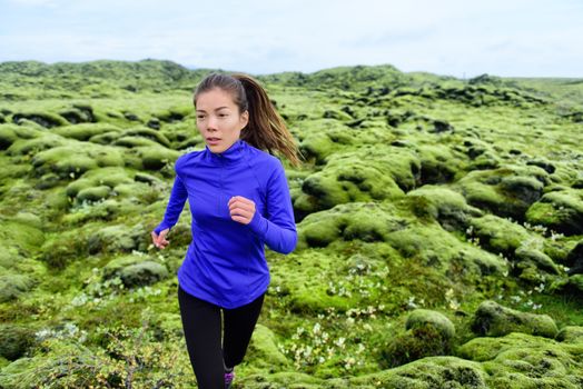 Athlete trail runner - running woman exercising. Fit female sport fitness model training jogging outdoors living healthy lifestyle in beautiful nature, Iceland.