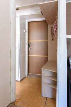 Entrance hall in a small apartment with an outdated interior