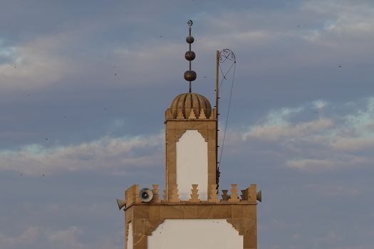 Moroccan mosk tower in the blue sky.