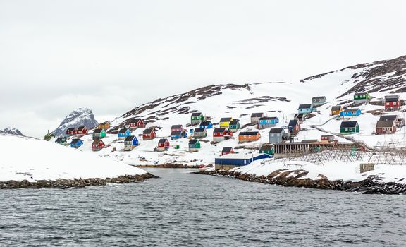 Colorful arctic fishing village houses at the rocky fjord  in the middle of nowhere, Kangamiut, Greenland