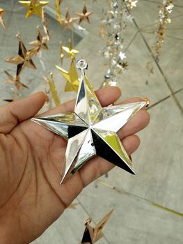 Man Hand and decoration star and Merry Christmas and Happy new years.