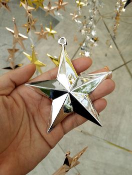 Man Hand and decoration star and Merry Christmas and Happy new years.