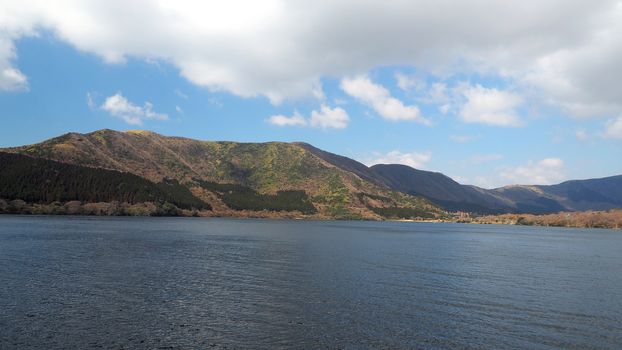 Hill and lake and clear blue sky and white clouds at five lakes near Kawaguchiko Tokyo Japan in winter season.