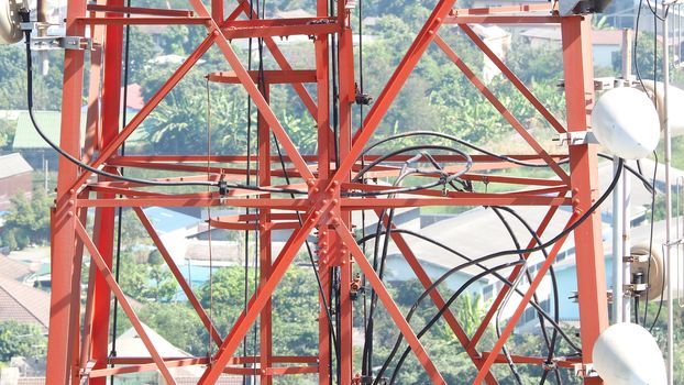 Telecommunication tower closeup with red and white color.